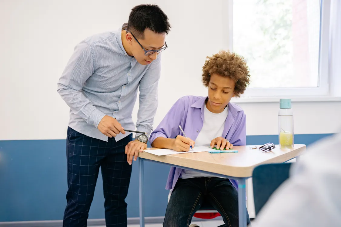 Teacher helping a teen student prepare for the move to high school